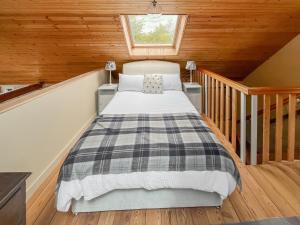 a bedroom with a bed in a attic at Munns Farm Barn in Earls Colne