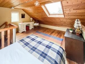a bedroom with a bed and a desk and a window at Munns Farm Barn in Earls Colne +7 photos