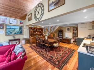 a living room with a red couch and a table at Munns Farm Barn in Earls Colne