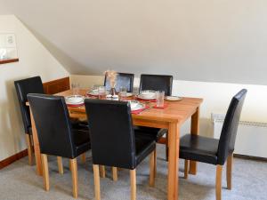 a dining room table with black chairs around it at Solace - Ukc2122 in Stalham