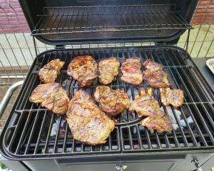 a grill with a bunch of meat on it at Retro House in Pantelimon