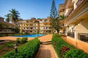 a resort with a swimming pool and a building at Harmony Vista in Calangute