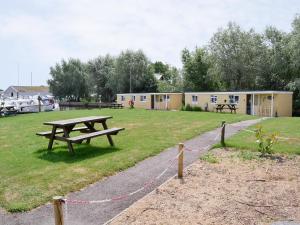 a park with a picnic table and a building at Halcyon - Uk12696 in Stalham