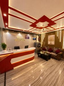 a lobby with a reception desk and a couch at Hotel R-A-M-A-N-S-H GRAND INN - Beside Ram Mandir Ayodhya 96,7000,2101 in Ayodhya