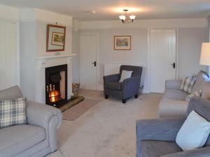 a living room with two couches and a fireplace at Riverside - Ukc2296 in Stalham