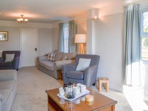 a living room with a couch and chairs and a table at Riverside - Ukc2296 in Stalham