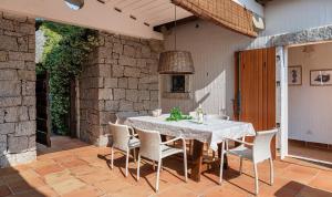 a dining table and chairs on a patio at Li Conchi 44 in Castiadas