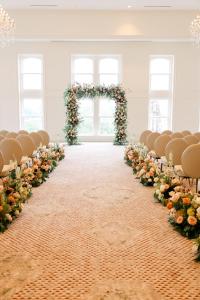 an aisle with an altar and chairs with flowers at The Hotel Monroe, Tapestry Collection By Hilton in Monroe