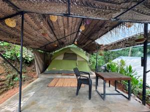 a tent with a table and a chair in front of it at Sri Craft Algama in Uduwaka