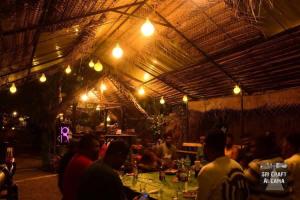 a group of people sitting at a restaurant at night at Sri Craft Algama in Uduwaka