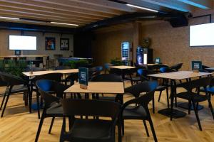 a dining room with tables and chairs and screens at Auberge du Parc in Delémont