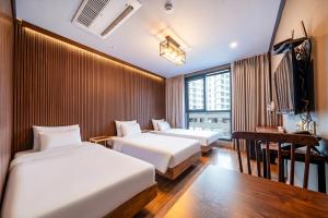 a hotel room with two beds and a window at Benikea Hotel Kakao in Seoul