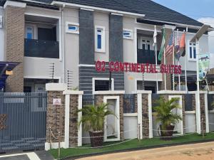 a building with a sign on the side of it at O2 Continental Suites in Kubwa