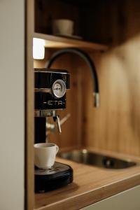 a coffee machine sitting on top of a counter at KRUSHPOINT Krušnohorský hotel in Horní Blatná +40 photos