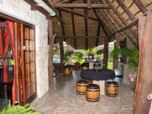 an outdoor patio with a table and barrels at Art Guest House in Lutzville