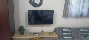 ein Wohnzimmer mit einem Flachbildfernseher an der Wand in der Unterkunft Lemon Suites in Mytilini + 2 Fotos