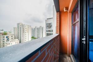 a balcony of a building with an open door at Benikea Hotel Kakao in Seoul