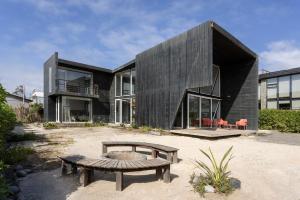 a house with a bench in front of it at Casas Punta Costanera in Pichilemu