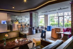 a lobby of a hotel with couches and a bar at Mirotel Resort and Spa in Truskavets