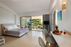 a bedroom with a bed and a dining room with a table at Villa Baronnos in Gaios