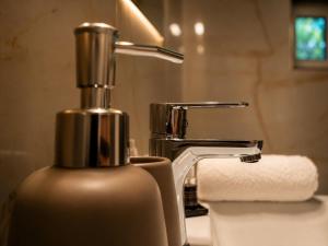 a bathroom sink with a faucet and a paper towel at Chata Medvedík in Turík +39 photos