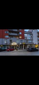 a group of buildings with cars parked in a parking lot at Penzion City in Púchov
