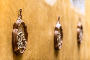 a wall with three different types of lights on it at Europe Hôtel in Castres