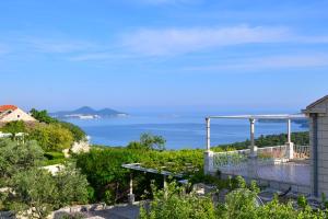 a view of the ocean from the balcony of a house at Apartment & Room Ladisic in Orasac