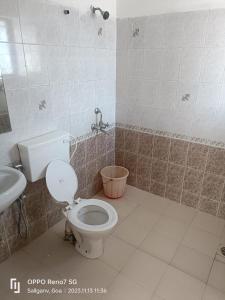 a bathroom with a toilet and a sink at Harmony Vista in Calangute +16 photos