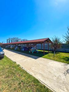 a park with a pavilion with a picnic table and a pavilionintendentintendent at Relax by the Sea Camping next to Nibiru in Costinesti