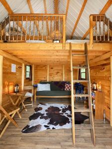 a bedroom with a bunk bed in a log cabin at Off-Grid Treehouse White Mountain National Forest in North Lovell