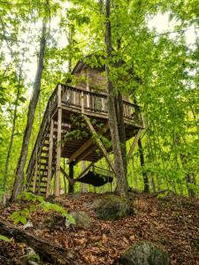 a tree house in the middle of the woods at Off-Grid Treehouse White Mountain National Forest in North Lovell