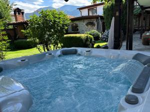 a hot tub with water in a backyard at Klecherova House in Bansko