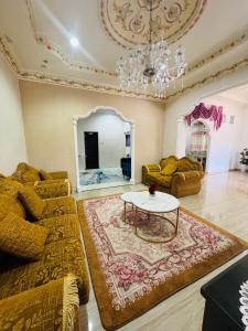 a living room with a couch and a table at Taman Darul Salam Homestay Pasir Puteh in Pasir Puteh