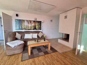 a living room with a couch and a coffee table at Ski- und Wanderurlaub im Wald Ferienhaus Adlerblick in Schnett