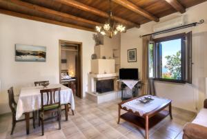a living room with a table and a fireplace at Rodoula apts By Comfortbnb in Roússa Ekklisía