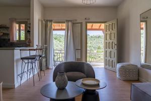 a living room with a chair and a table at Flower in Skiathos