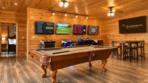 a billiard room with a pool table and a bar at Gatlinburg Mansion Cabin in Pittman Center