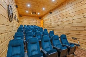 a conference room with blue chairs in it at Gatlinburg Mansion Cabin in Pittman Center