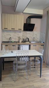a kitchen with a table and chairs in it at hotel G&G in Tsaghveri