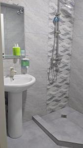 a bathroom with a sink and a shower at hotel G&G in Tsaghveri
