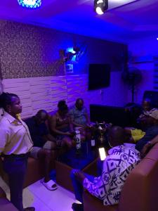 a group of people sitting in a living room at Diamond Groove Hotel & Suites in Sangotedo +17 photos