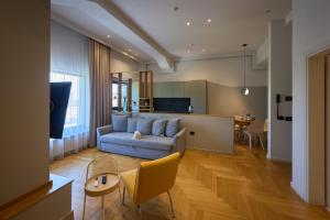a living room with a couch and a table at Atlas Aparthotel & Spa in Piatra Neamţ