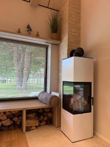 a living room with a fish tank and a window at Beiri in Dravnieki +3 photos