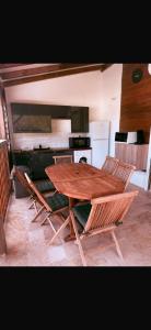 a wooden table and chairs in a kitchen at Caress antillaise in Deshaies