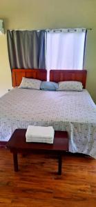 a bed with a table with two towels on it at Bosque Alto Lodge in Platanal