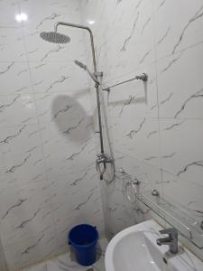 a shower in a bathroom with a toilet and a sink at O2 Continental Suites in Kubwa +18 photos