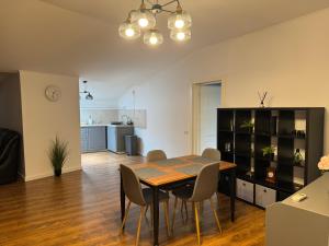 a dining room and kitchen with a table and chairs at Dare apartments 1 in Giurgiu
