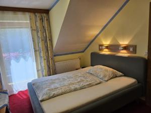 a small bed in a room with a window at Haus am Schönberg in Sooss