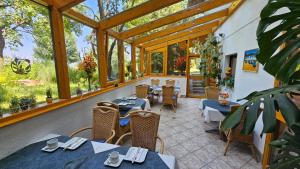 a restaurant with tables and chairs and windows at Haus am Schönberg in Sooss